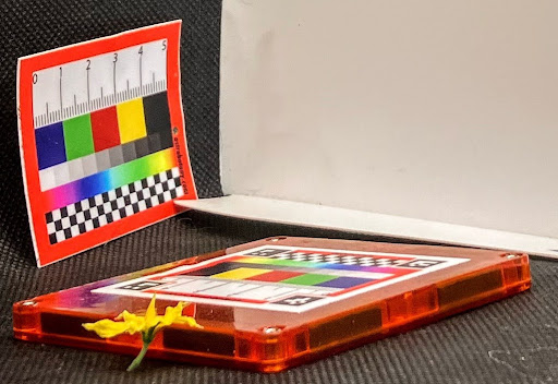 Here the SPECTRUM sticker is mounted to a plastic tile to make it flat, in the background you can see an older version of the sticker standing up and curving as it’s not stuck to a surface.